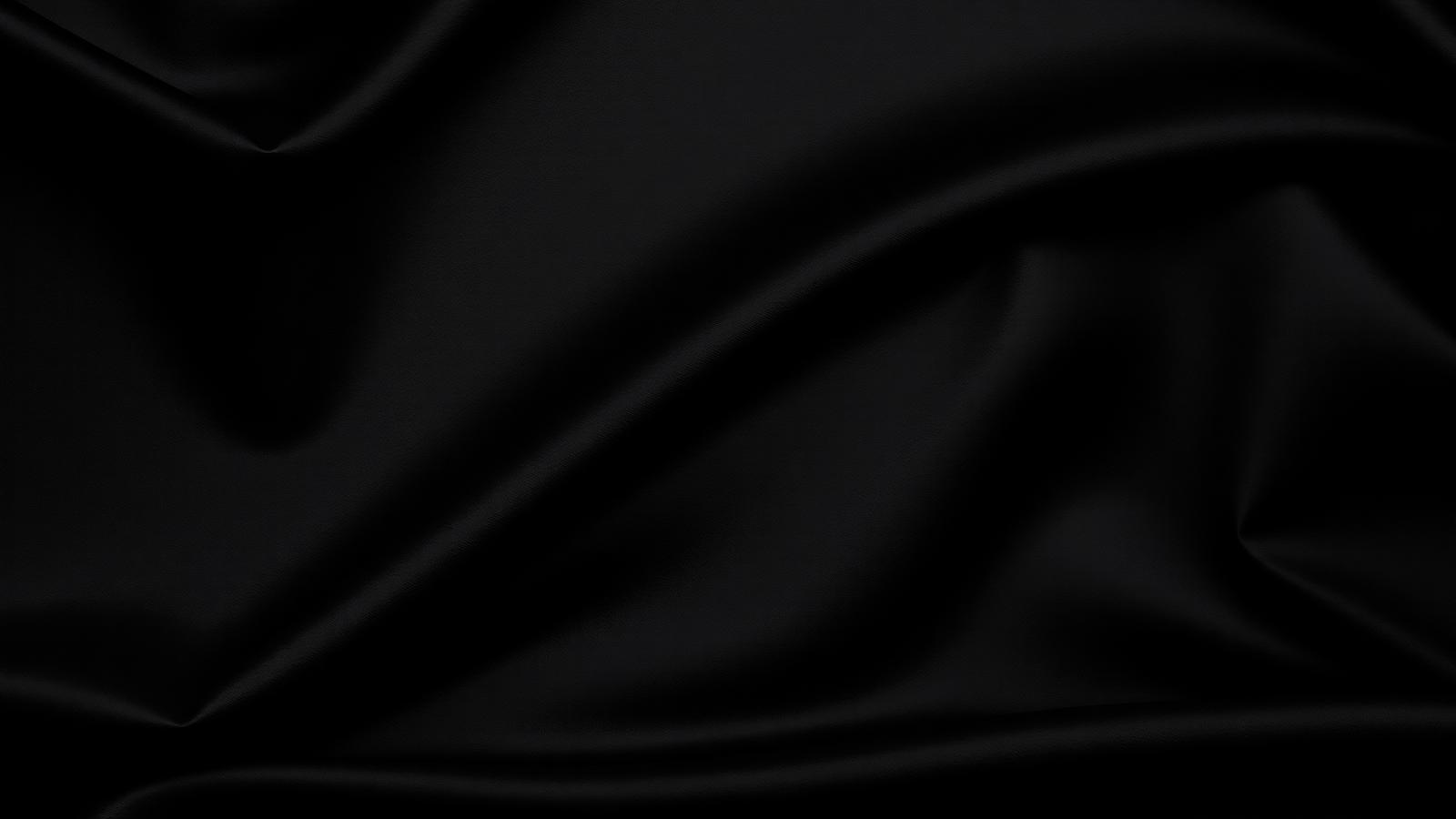 Black satin backdrop of the Loc'd By Jasmine studio